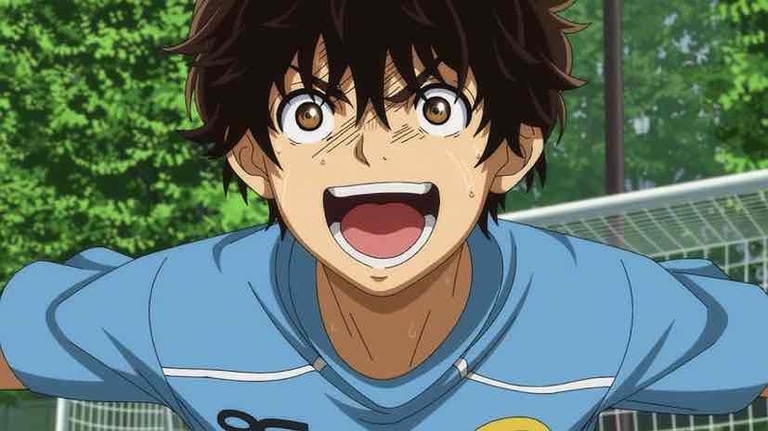 Ashito Aoi, the protagonist from the <em>Ao Ashi</em> anime, celebrates with an excited expression on the soccer field.