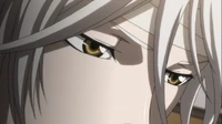 A close-up of Shogo Makishima's intense amber eyes and white hair in Psycho-Pass.