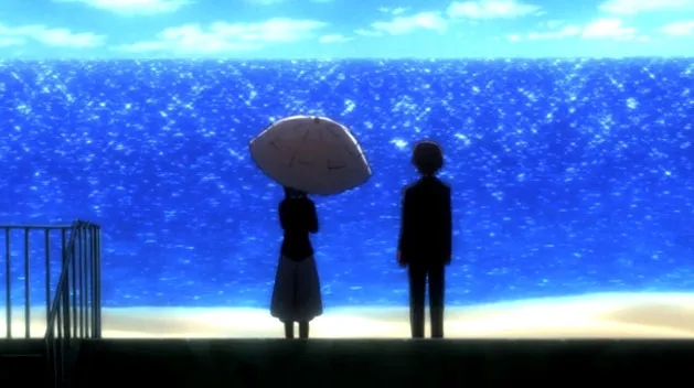 Silhouetted figures on pier overlooking ocean