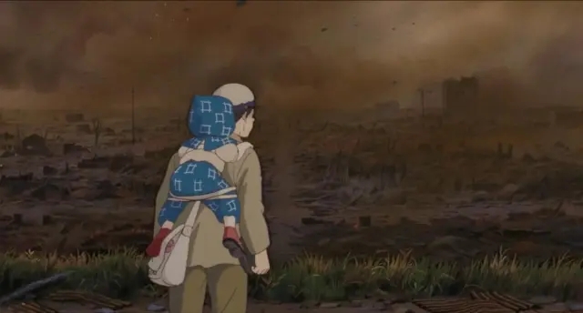 Seita carries his sister Setsuko through the devastated landscape in the anime film Grave of the Fireflies, directed by Isao Takahata.