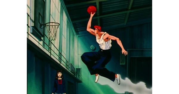 Hanamichi Sakuragi performing a slam dunk during a basketball game in the anime series Slam Dunk.